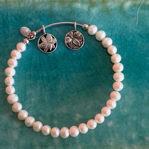 PEARL BANGLE WITH CHARMS